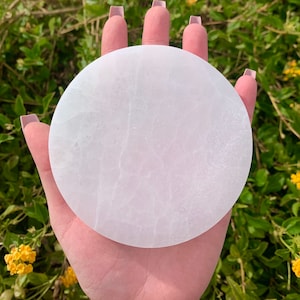 May include: A white selenite charging plate, a smooth, round disc of polished selenite crystal, perfect for charging crystals or other items.