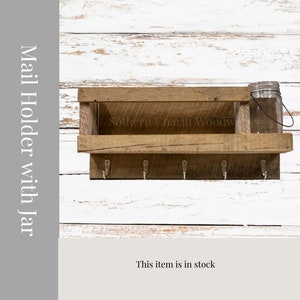 May include: Rustic wooden mail holder with a shelf and hooks. The holder is made of reclaimed wood and has a natural finish. It is labeled "Southern Charm Woodworks".