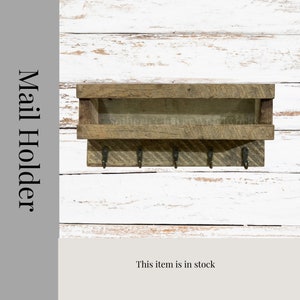 May include: Rustic wooden mail holder with a shelf and five hooks. The holder is stained a dark brown color and has a distressed finish. The text "Mail Holder" is written vertically on the left side of the image.
