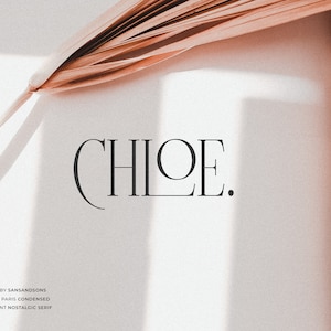 May include: A close-up of the word "CHLOE." written in a black serif font on a white background. The text is surrounded by a shadow from a light source above. The text is accompanied by the words "MADE BY SANSANDISONS HELLO PARIS CONDENSED ELEGANT NOSTALGIC SERIF".