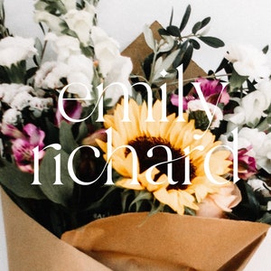 May include: A bouquet of flowers in brown paper wrapping, including white and purple flowers, and a large yellow sunflower. The text "emily richard" is written in white script over the flowers.