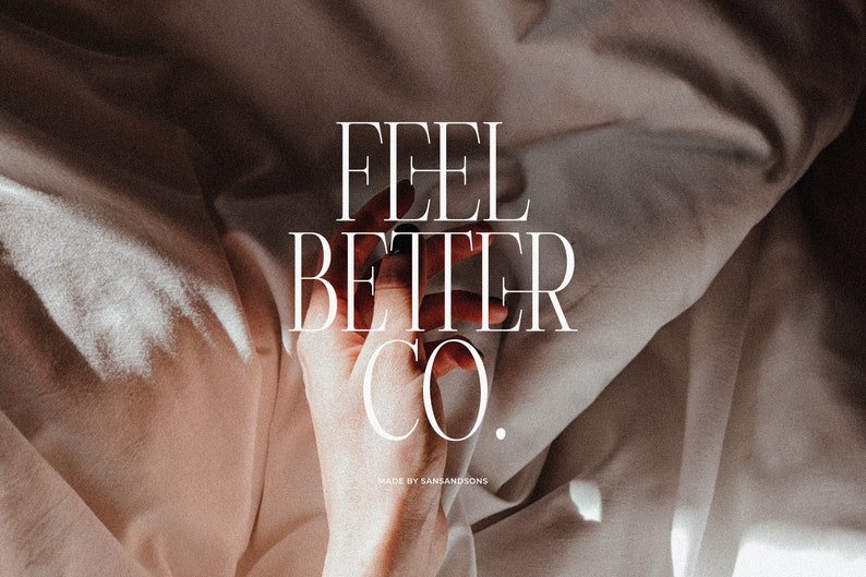 May include: A close-up of a hand holding a white sheet with the text "FEEL BETTER CO." in a minimalist font. The text is centered on the sheet and is surrounded by a white background. The text "MADE BY SANSANDSONS" is in a smaller font below the main text.