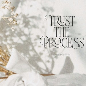 May include: A white background with a shadow of dried flowers and the text "TRUST THE PROCESS" in a black serif font. The text "MADE BY SANSANDSONS" is in a smaller font below the main text.