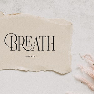 May include: A beige paper with torn edges featuring the text "BREATH SLOW & CO."