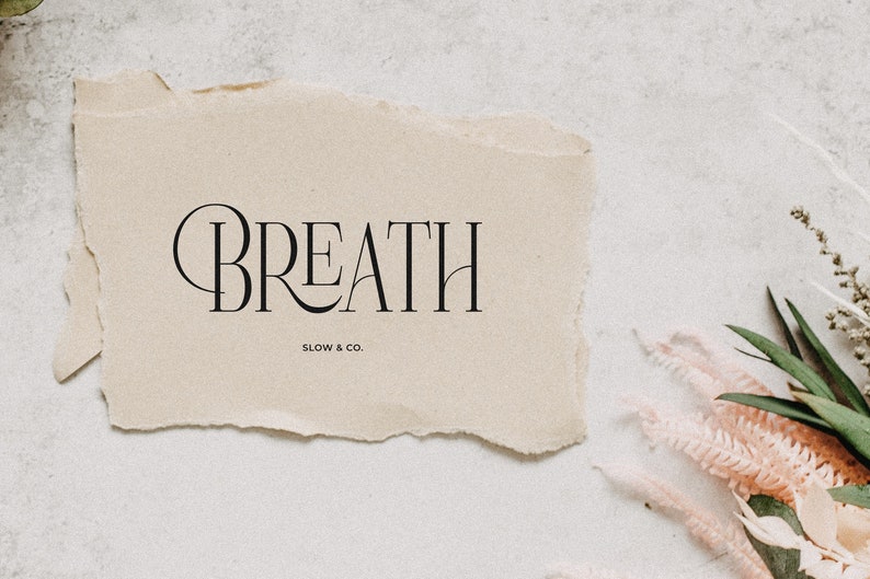 May include: A beige paper with torn edges featuring the text "BREATH SLOW & CO."