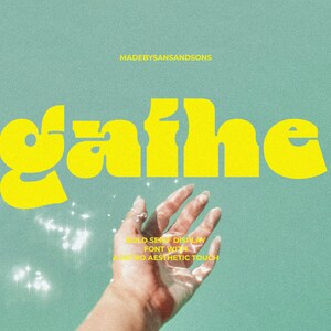 May include: A yellow retro font with the word "gaihe." The font is bold and has a playful, retro aesthetic. The word is on a light blue background with a hand reaching up from the bottom of the image.