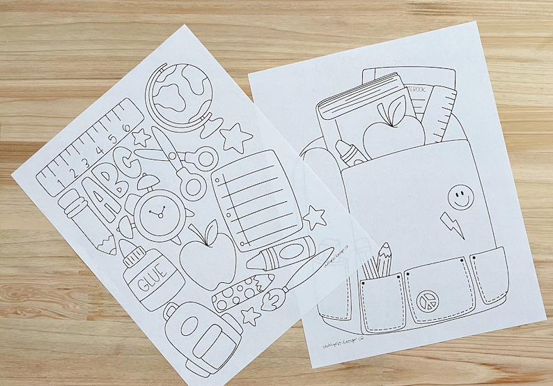 May include: Two black and white printable coloring pages featuring school supplies. The first page includes a ruler, pencil, scissors, globe, alarm clock, glue, apple, notebook, crayon, paintbrush, and a backpack. The second page features a backpack with a book, notebook, ruler, apple, crayon, pencils, and a peace sign.