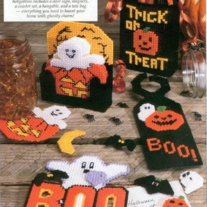 May include: A collection of Halloween-themed crafts, including a tote bag, a door sign, a coaster set, and a hangable. The crafts feature ghosts, pumpkins, and bats. The text "Trick or Treat" and "Boo!" are visible on the crafts.