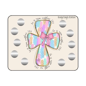 May include: A pastel pink and blue cross with a gold glitter design and a pink bow. The cross has the text "He is risen Matthew 28:6" written around it. The image is on a beige background with 9 silver circles.