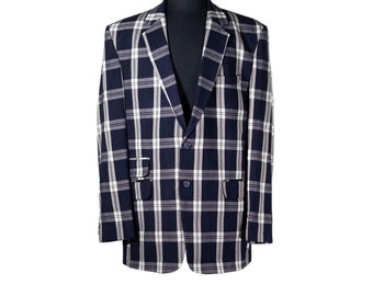 May include: A navy blue blazer with a white and black plaid pattern. The blazer has a single button closure and two flap pockets.