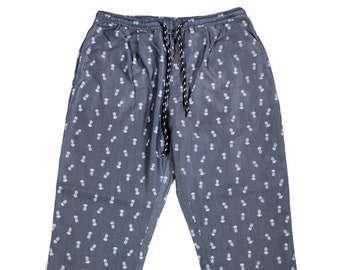 May include: Gray pants with a white pineapple pattern. The pants have an elastic waistband with a drawstring.