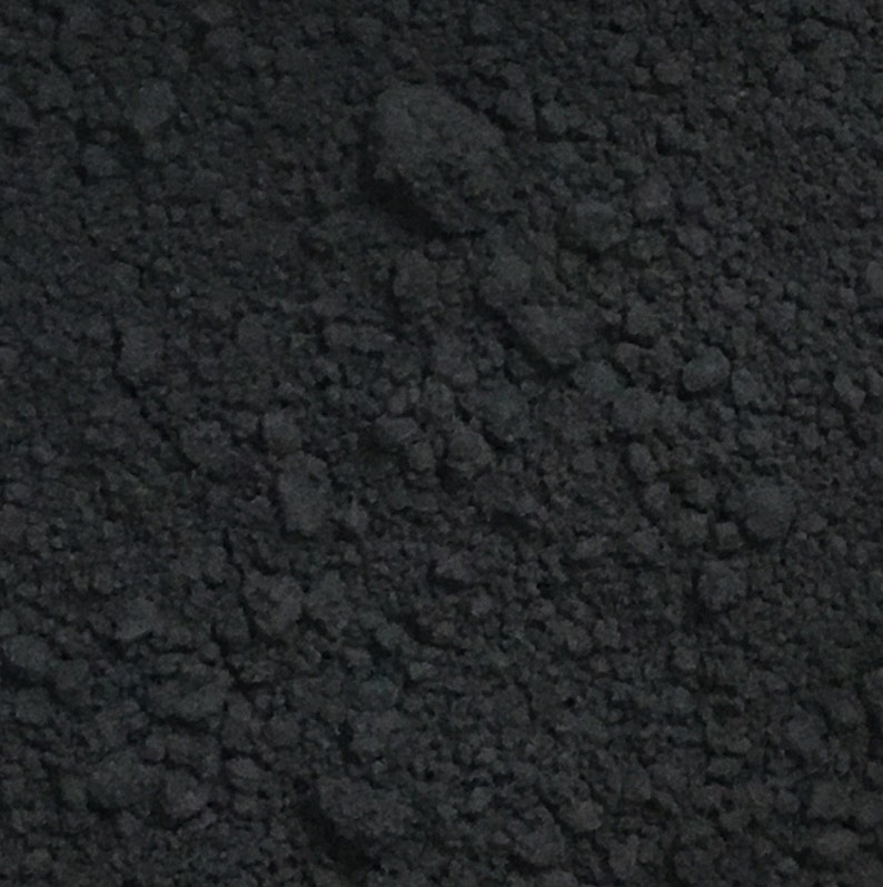 May include: Close-up of a black powder, showing its fine texture and dark color.