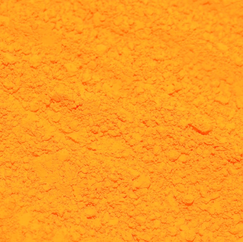 May include: Close-up of a bright orange powder, possibly turmeric or paprika, with a fine, granular texture.