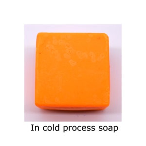 May include: A square bar of orange cold process soap.