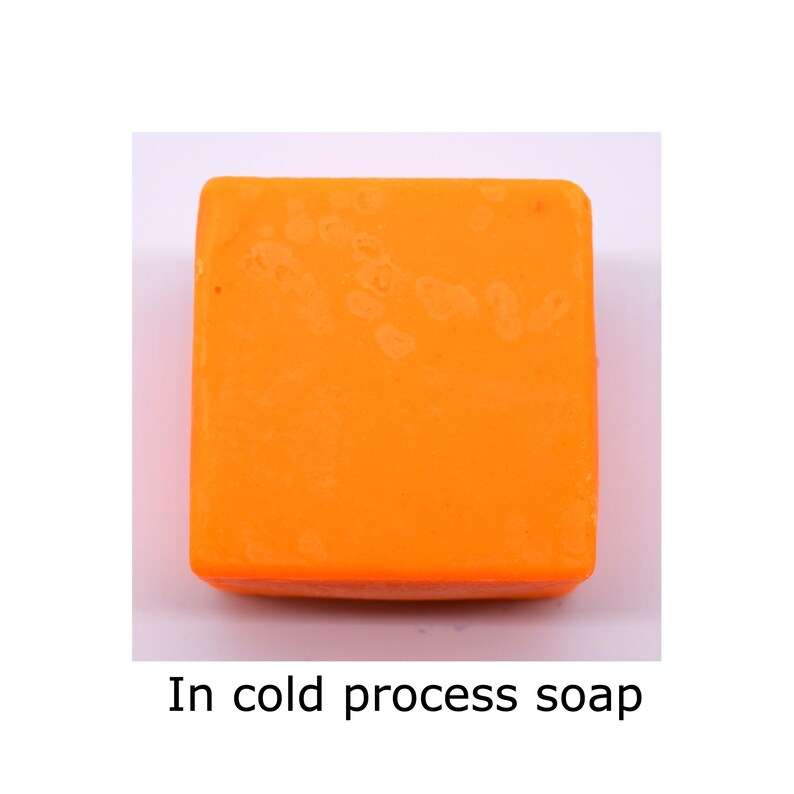 May include: A square bar of orange cold process soap.