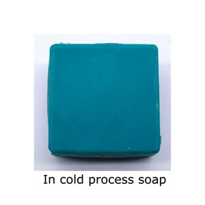 May include: A square bar of teal-colored soap. In cold process soap.