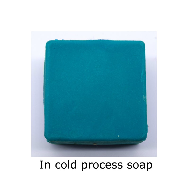 May include: A square bar of teal-colored soap. In cold process soap.