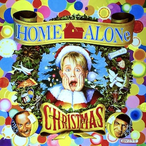 May include: A colorful Christmas-themed poster featuring a young boy with a shocked expression, wearing a Santa hat and red and white clothing. The poster has the words "Home Alone Christmas" in large, gold letters and a red house icon.