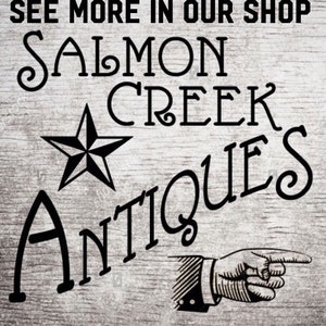 May include: Black and white sign with the text "See more in our shop Salmon Creek Antiques" with a star and a pointing hand.