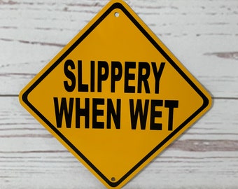 Slippery When Wet Metal Caution Sign - Yellow Safety Sign