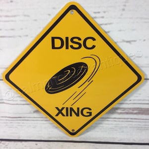 Mini señal metálica amarilla de precaución de cruce Disc Xing, 15 x 15 cm o 30 x 30 cm. NUEVO disco golf Frisbee (2 tamaños disponibles).