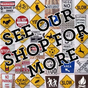 May include: A collection of colorful metal signs with various warnings, rules, and messages. The signs are arranged in a grid pattern and feature a variety of designs, including animals, traffic symbols, and text. The signs are all in a vintage style and have a distressed look. The text on the signs includes phrases like "See Our Shop For More", "Warning Beware of Owner", "Do Not Enter", "Cat", "Dad's Garage", "This is a No Whining Zone", "Slow", "Squirrel", "Yif", "Hell With The Dog Beware of Owner", "Clothing Optional Beyond", "Stop", "Soccer", "Private Property", "Reserve Parking Your Text Here", "Speed Limit 100", "No Parking Any Time", "Dead End", "Disc Xing", "Rest Area", "Slow", "Railroad Crossing", and "Fire".