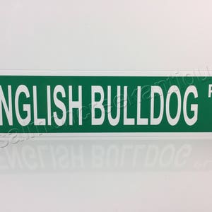 May include: Green and white metal sign with the text "ENGLISH BULLDOG" and the letters "PL" in the top right corner.