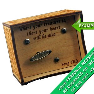 May include: A wooden music box with a decorative design on the sides. The top of the box has a slot for a music sheet and a message that reads "Where your treasure is, there your heart will be also." The bottom of the box has a space for a personalised message to be engraved.