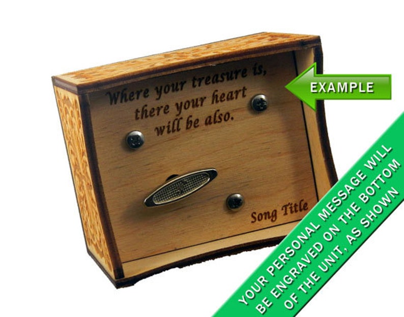 May include: A wooden music box with a decorative design on the sides. The top of the box has a slot for a music sheet and a message that reads "Where your treasure is, there your heart will be also." The bottom of the box has a space for a personalised message to be engraved.