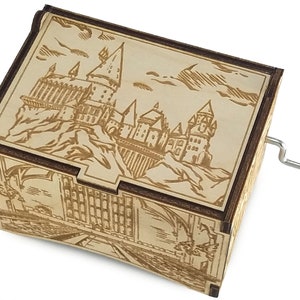 May include: A wooden music box with a hand-crank on the side. The top of the box features a laser-engraved image of Hogwarts castle from the Harry Potter series.