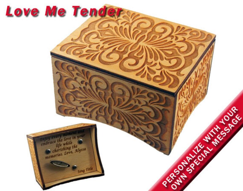 May include: A wooden music box with a floral design. The music box is engraved with the words 'Love Me Tender' and has a personalized message area. The music box is open and the inside is visible. The music box has a small compartment for a song title and a small compartment for a personalized message. The music box is made of wood and has a natural finish. The music box is a great gift for any occasion.