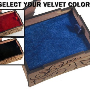 May include: A wooden box with an intricate carved design and a velvet lining. The box is open and the inside is lined with blue velvet. The text "SELECT YOUR VELVET COLOR!" is visible at the top of the image.