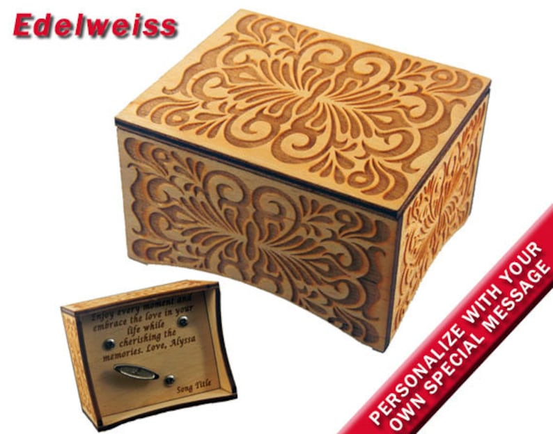 May include: A wooden music box with an intricate floral design. The box is closed and has a small plaque on the side with the text "Enjoy every moment and embrace the love in your life while cherishing the memories. Love, Alyssa". The box is personalized with the text "PERSONALIZE WITH YOUR OWN SPECIAL MESSAGE".