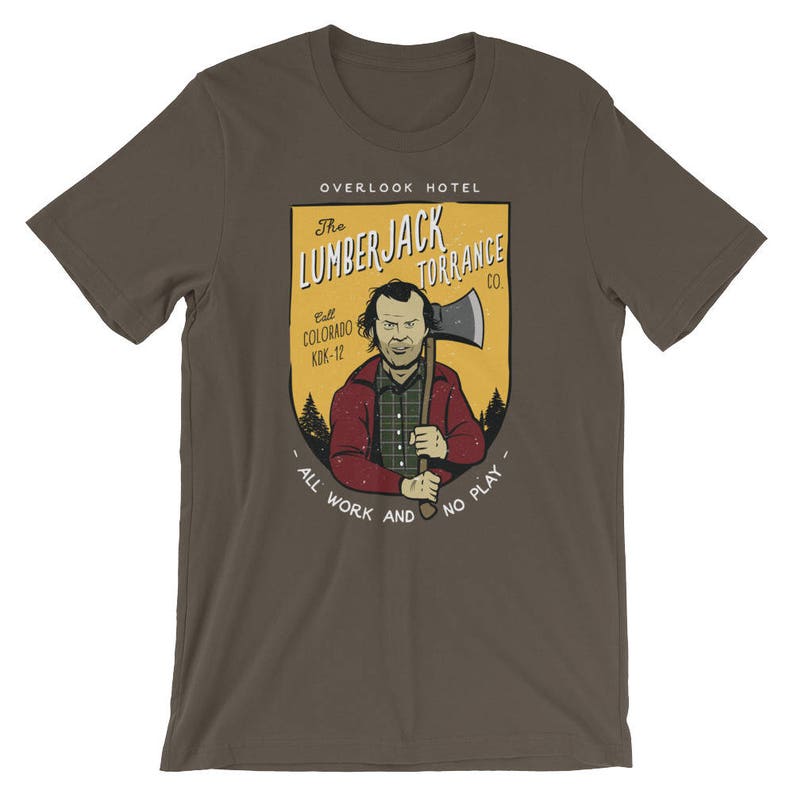 Może przedstawiać: Brązowy t-shirt z grafiką przedstawiającą mężczyznę trzymającego siekierę. Grafika znajduje się w ż&oacute;łtej i pomarańczowej ramce z tekstem "The Lumberjack Torrance Co." i "All work and no play".