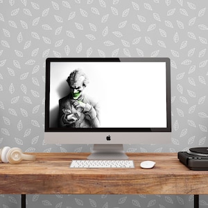 May include: A wooden desk with a computer, two speakers, a turntable, and headphones. The wall behind the desk has a white leaf pattern.