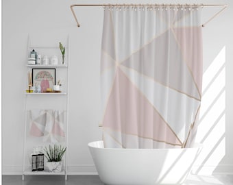 May include: A white bathroom with a white bathtub, a white shelf with various items, and a pink and white geometric shower curtain.