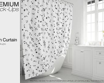 May include: A white shower curtain with a black musical note pattern. The curtain is hanging in a bathroom with a white bathtub and white cabinets.