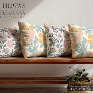 May include: Four throw pillows with floral patterns in shades of pink, yellow, and blue, resting on a wooden bench. The pillows feature a variety of flower designs. The image also includes text: "THROW PILLOWS PSD MOCKUPS".