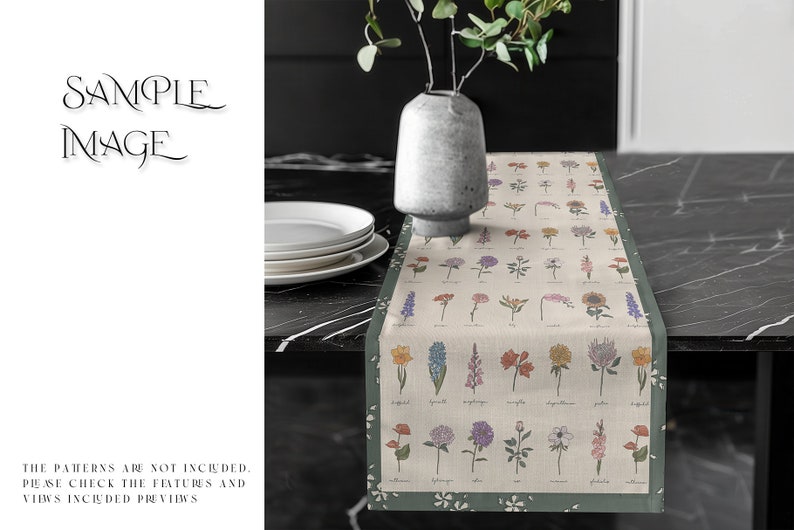 May include: A beige table runner with a green border features a floral pattern with various flowers and leaves. The runner is on a black table with white plates stacked on the side.