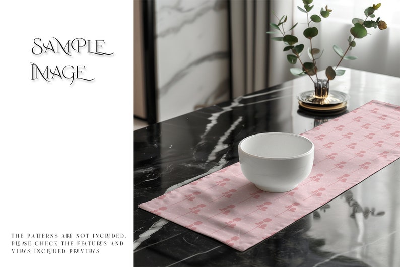 May include: A pink table runner with a delicate floral pattern sits on a black marble table. A white bowl is placed on the runner, and a small potted plant is in the background.