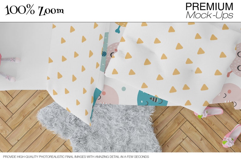 May include: A white bed sheet with a yellow triangle pattern and a blue and pink cartoon design. The sheet is folded over a white fluffy rug on a wooden floor.