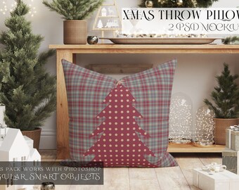May include: Two Christmas throw pillows featuring a plaid pattern and a red and white polka dot Christmas tree design. The pillows are displayed on a wooden table with a Christmas tree and other festive decorations.