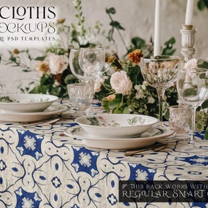 May include: A table setting with a white tablecloth with a blue and white geometric pattern. The table is set with white plates, bowls, and glasses. There are flowers in the background.