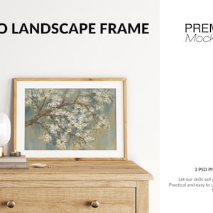 May include: A wooden frame with a white mat and a print of a flowering tree branch. The frame is sitting on a wooden dresser with a lamp and a book on top. The text "BOHO LANDSCAPE FRAME" is at the top of the image. The text "PREMIUM Mock-Ups" is at the top right of the image.