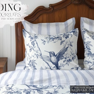 Puede incluir: Una cama blanca con ropa de cama a rayas azul y blanca y dos almohadas con un patrón floral y un diseño de colibrí. La cabecera está hecha de madera y tiene un diseño tallado.