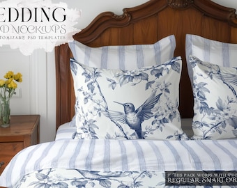 May include: A white bed with blue and white striped bedding and two pillows with a floral pattern and a hummingbird design. The headboard is made of wood and has a carved design.