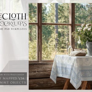 May include: A white tablecloth with a blue floral border is draped over a wooden table. A metal bucket filled with white flowers sits on the table near a window. The text "TABLECLOTH PSD MOCKUPS" is at the top.