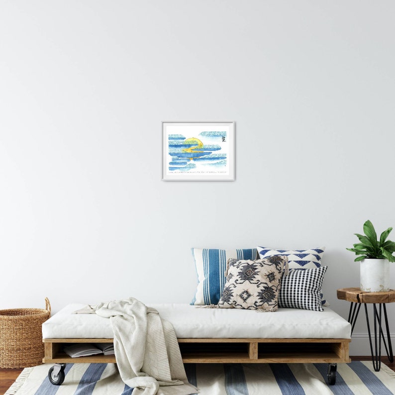 May include: A framed watercolour painting of a yellow sun setting behind blue and white clouds. The painting is titled "The Sun Sets on the Horizon" and is signed with a black brushstroke.