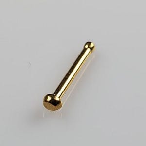 May include: A gold nose ring with a rounded end.