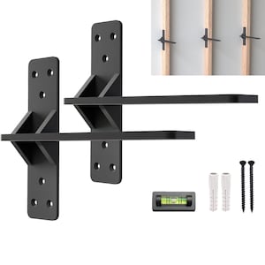 May include: Two black metal shelf brackets with a level and two plastic anchors and screws. The brackets are designed to be mounted to a wall stud.